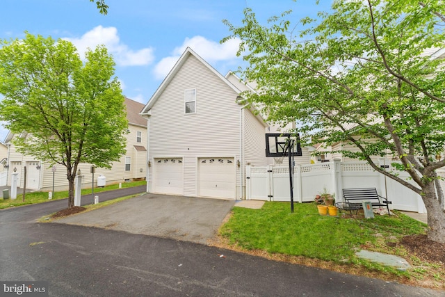 17435 Lethridge Cir, Round Hill, VA 20141 - view of home's exterior with asphalt driveway, a garage, a gate, and fence