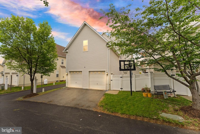 17435 Lethridge Cir, Round Hill, VA 20141 - property exterior at dusk featuring driveway, a garage, fence, and a gate