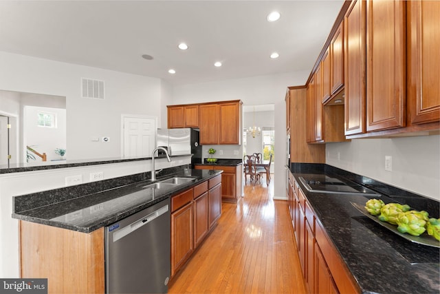 17435 Lethridge Cir, Round Hill, VA 20141 - kitchen with appliances with stainless steel finishes, a sink, brown cabinets, recessed lighting, and light wood finished floors