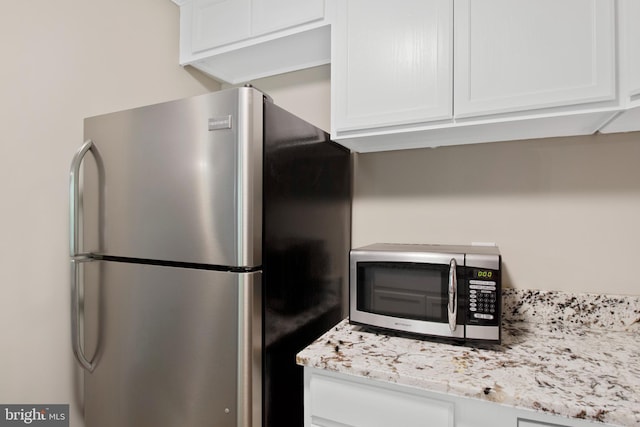 kitchen featuring appliances with stainless steel finishes and white cabinetry