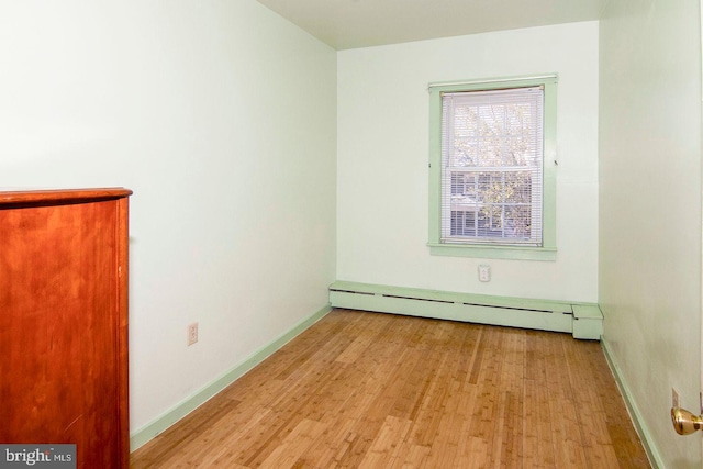 330 E Broadway, Salem, NJ 08079 - spare room featuring baseboards, baseboard heating, and wood finished floors