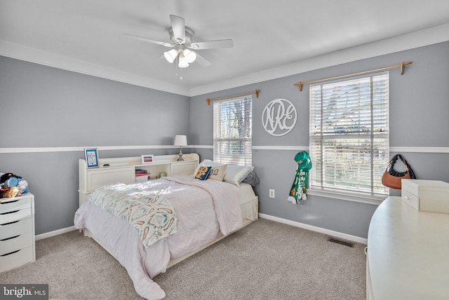 carpeted bedroom featuring visible vents, ceiling fan, and baseboards