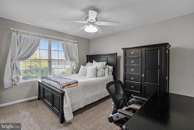 carpeted bedroom featuring ceiling fan and baseboards
