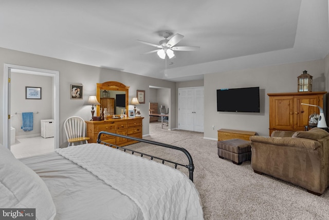 bedroom with ceiling fan, a closet, baseboards, carpet, and ensuite bath