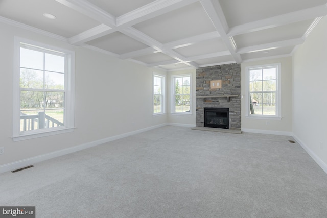 unfurnished living room featuring coffered ceiling, visible vents, and plenty of natural light