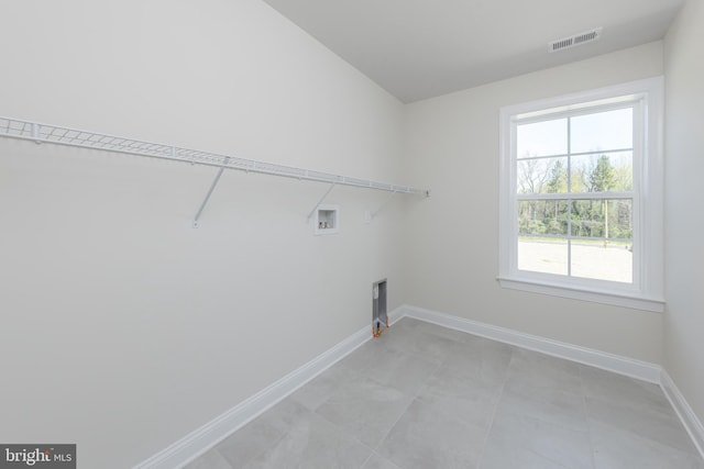 washroom featuring baseboards, visible vents, hookup for a washing machine, and laundry area