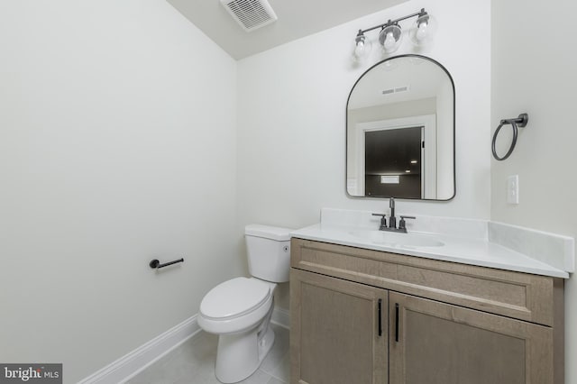 bathroom featuring tile patterned floors, visible vents, toilet, vanity, and baseboards