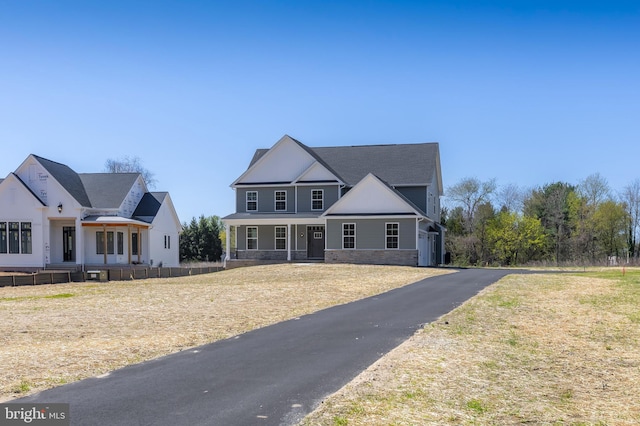 view of front of house with a porch and stone siding