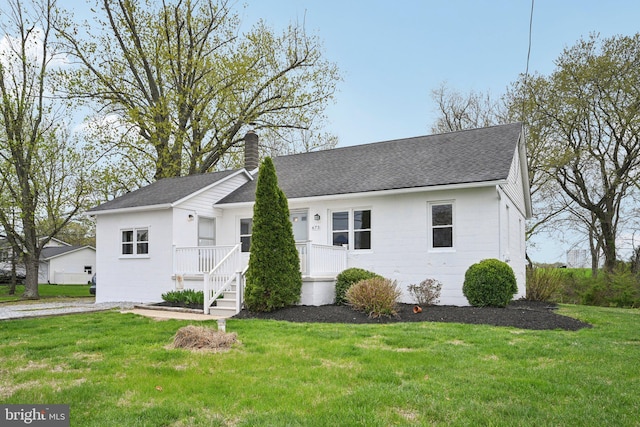 673 Harrisonville Rd, Swedesboro, NJ 08085 - view of front of home featuring a chimney, roof with shingles, and a front yard