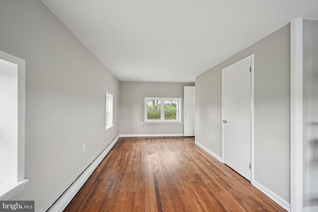 673 Harrisonville Rd, Swedesboro, NJ 08085 - unfurnished bedroom with wood-type flooring, a baseboard radiator, and baseboards