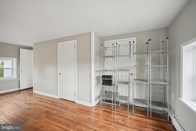 673 Harrisonville Rd, Swedesboro, NJ 08085 - unfurnished office with a baseboard heating unit, hardwood / wood-style flooring, and baseboards