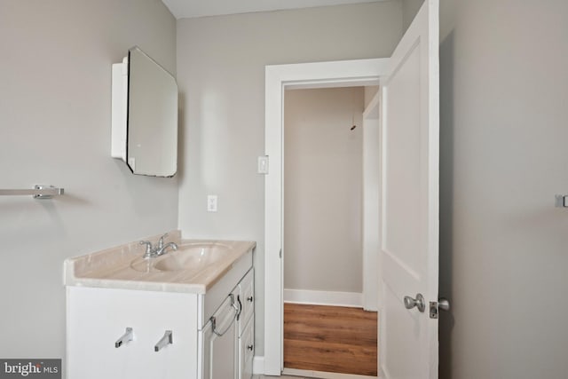 673 Harrisonville Rd, Swedesboro, NJ 08085 - bathroom featuring baseboards, wood finished floors, and vanity