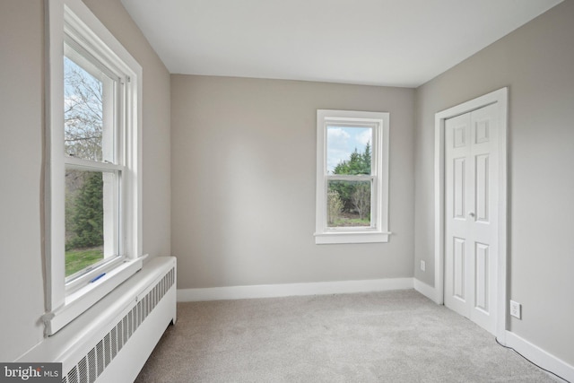673 Harrisonville Rd, Swedesboro, NJ 08085 - carpeted empty room featuring radiator, plenty of natural light, and baseboards