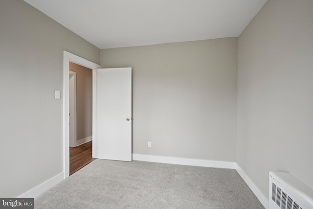673 Harrisonville Rd, Swedesboro, NJ 08085 - unfurnished room featuring radiator, baseboards, and carpet