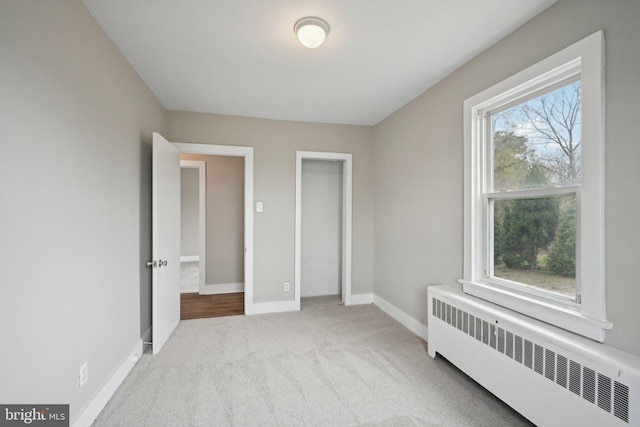 673 Harrisonville Rd, Swedesboro, NJ 08085 - unfurnished bedroom featuring radiator heating unit, carpet flooring, and baseboards