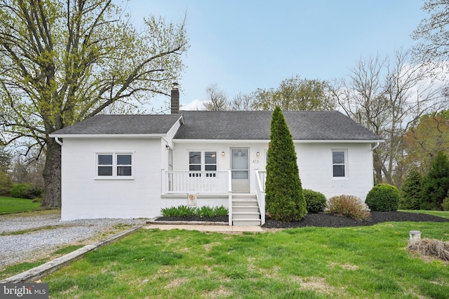 673 Harrisonville Rd, Swedesboro, NJ 08085 - single story home featuring concrete block siding, roof with shingles, a front lawn, a porch, and a chimney