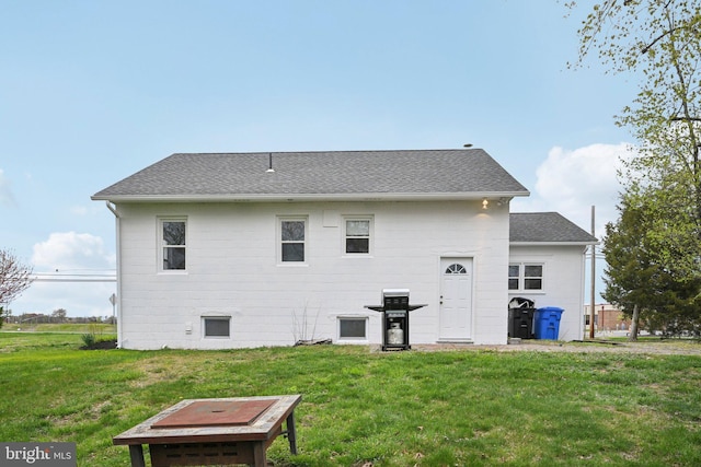 673 Harrisonville Rd, Swedesboro, NJ 08085 - rear view of house with a lawn and roof with shingles