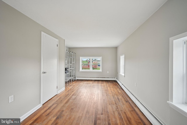 673 Harrisonville Rd, Swedesboro, NJ 08085 - unfurnished living room featuring a baseboard heating unit, baseboards, and hardwood / wood-style floors