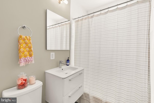 bathroom featuring toilet and vanity