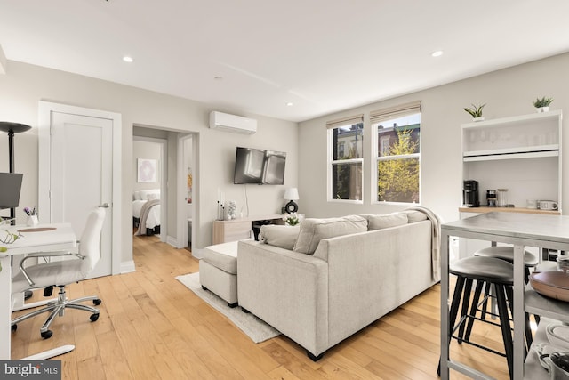 living area with light wood-style flooring, recessed lighting, and a wall mounted AC