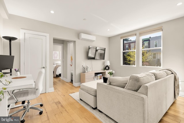 living room featuring an AC wall unit, baseboards, light wood-type flooring, and recessed lighting