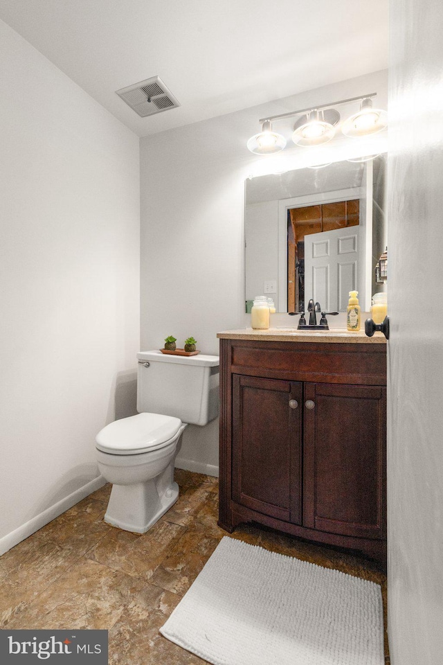1276 Courtney Ln, Belcamp, MD 21017 - half bathroom featuring toilet, baseboards, vanity, and stone finish flooring