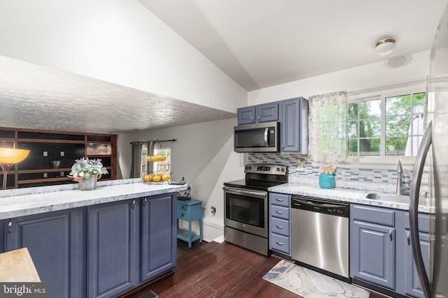 1276 Courtney Ln, Belcamp, MD 21017 - kitchen featuring stainless steel appliances, a sink, decorative backsplash, dark wood-type flooring, and vaulted ceiling