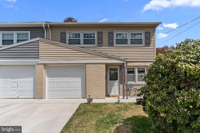 view of front of home featuring brick siding and driveway