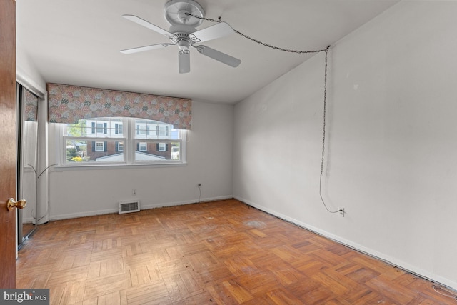 unfurnished room featuring ceiling fan, baseboards, and visible vents