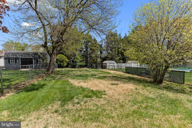 view of yard with a fenced backyard and an outdoor structure