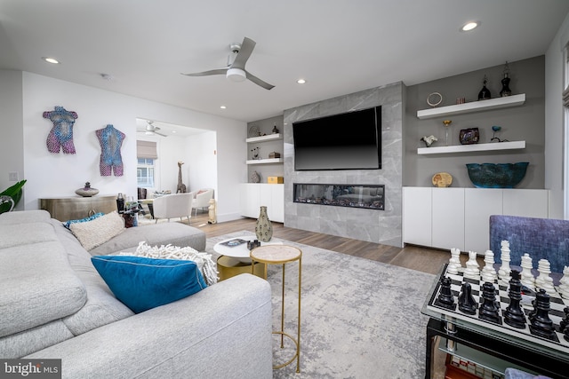 1181 Jennifer Ln, Manahawkin, NJ 08050 - living area featuring a premium fireplace, built in shelves, a ceiling fan, recessed lighting, and wood finished floors