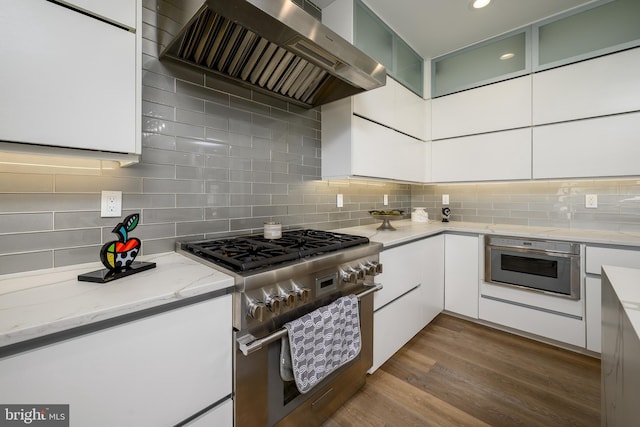 1181 Jennifer Ln, Manahawkin, NJ 08050 - kitchen featuring appliances with stainless steel finishes, backsplash, range hood, and light stone countertops