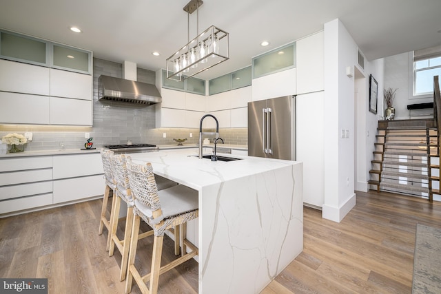 1181 Jennifer Ln, Manahawkin, NJ 08050 - kitchen featuring backsplash, modern cabinets, a sink, stainless steel appliances, and wall chimney exhaust hood