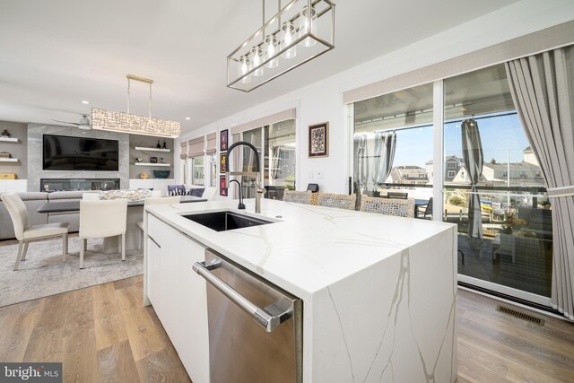 1181 Jennifer Ln, Manahawkin, NJ 08050 - kitchen featuring hanging light fixtures, a sink, stainless steel dishwasher, visible vents, and a center island with sink
