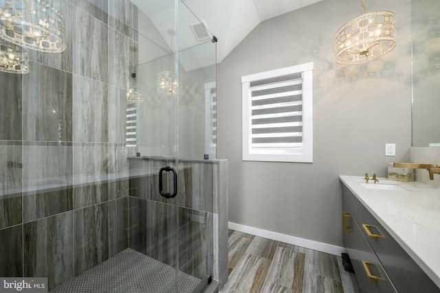 1181 Jennifer Ln, Manahawkin, NJ 08050 - bathroom with an inviting chandelier, vanity, baseboards, a shower stall, and vaulted ceiling