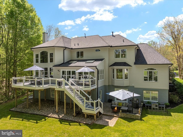 back of property featuring an outdoor living space, a chimney, a wooden deck, a patio area, and a yard