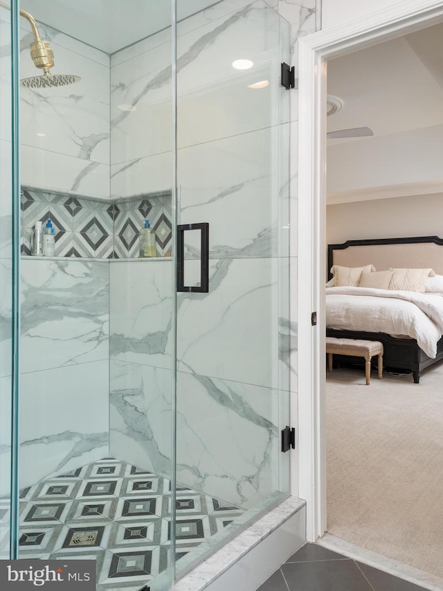 ensuite bathroom with tile patterned floors, a marble finish shower, and ensuite bathroom
