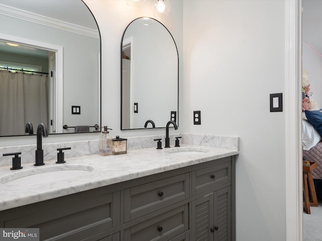 full bath with double vanity, ornamental molding, and a sink