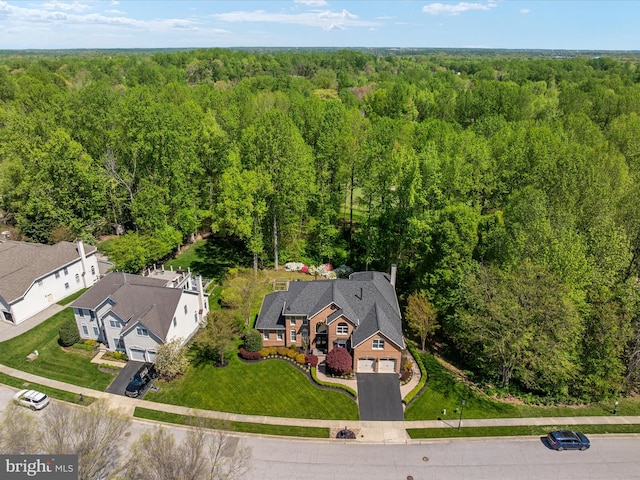 bird's eye view with a wooded view