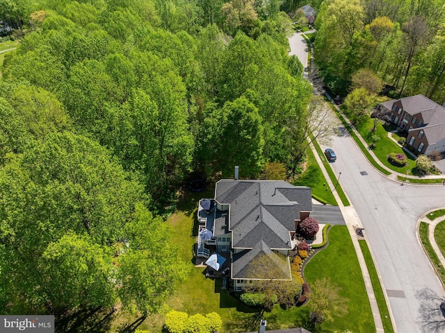 birds eye view of property featuring a view of trees