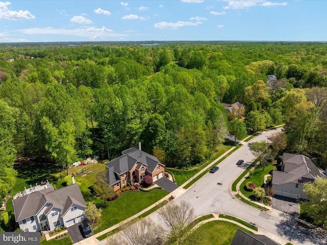 birds eye view of property featuring a wooded view
