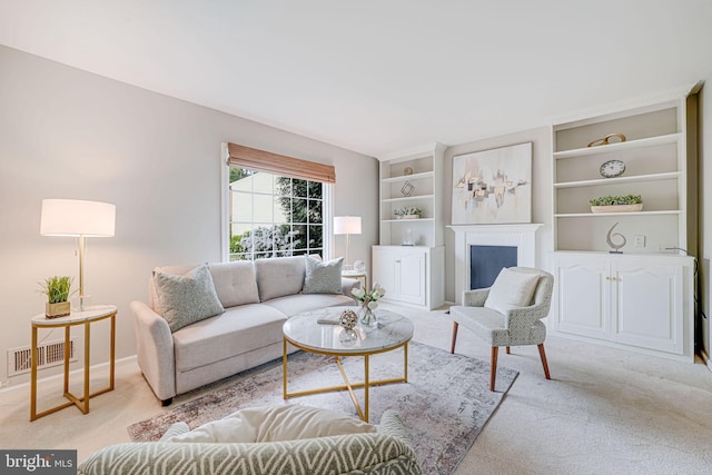 carpeted living room featuring built in features, baseboards, a fireplace, and visible vents