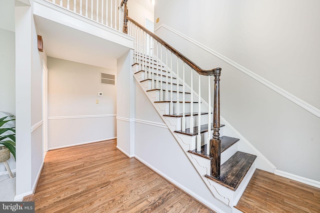 stairs featuring baseboards and wood finished floors