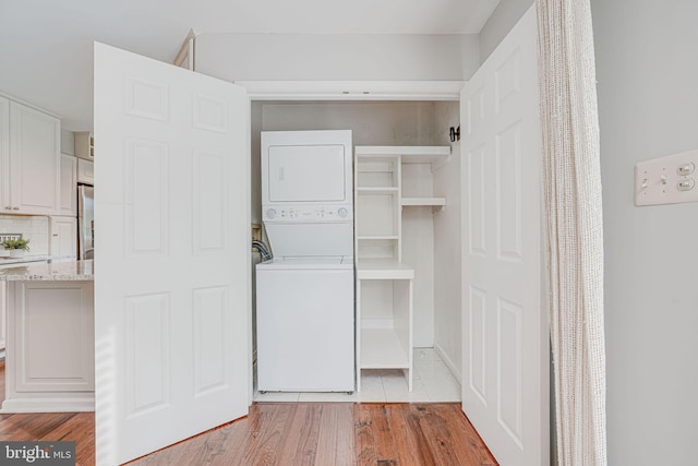 closet with stacked washer and clothes dryer