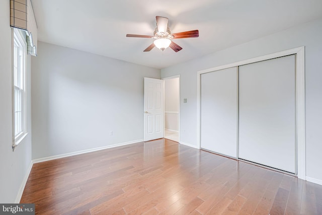 unfurnished bedroom with baseboards and wood finished floors
