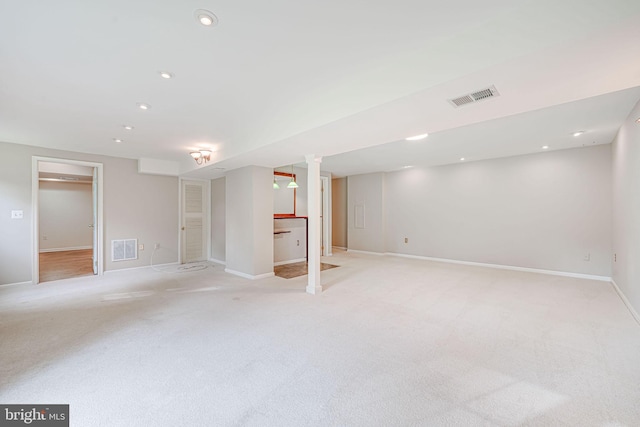 finished basement with baseboards, light carpet, recessed lighting, and visible vents