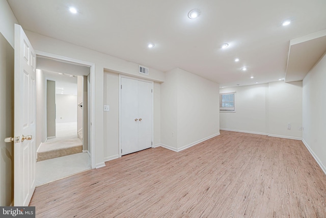finished basement with recessed lighting, baseboards, visible vents, and light wood finished floors