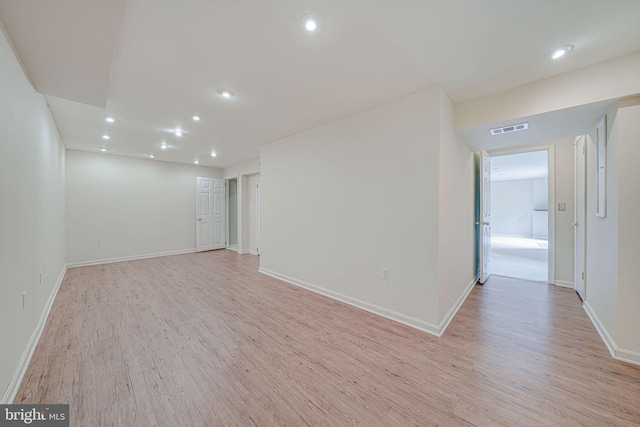 interior space featuring light wood-style floors, baseboards, recessed lighting, and visible vents