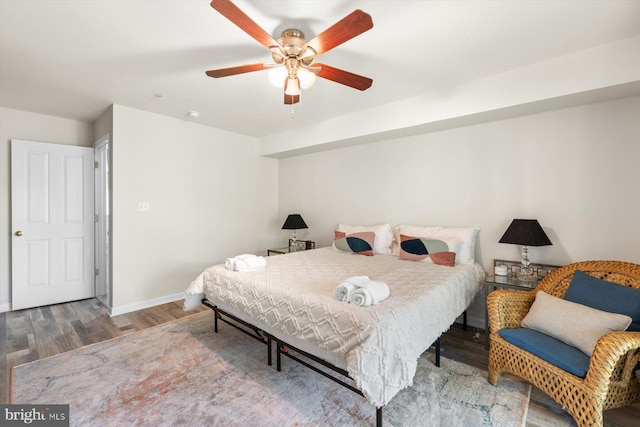 bedroom featuring baseboards, ceiling fan, and wood finished floors