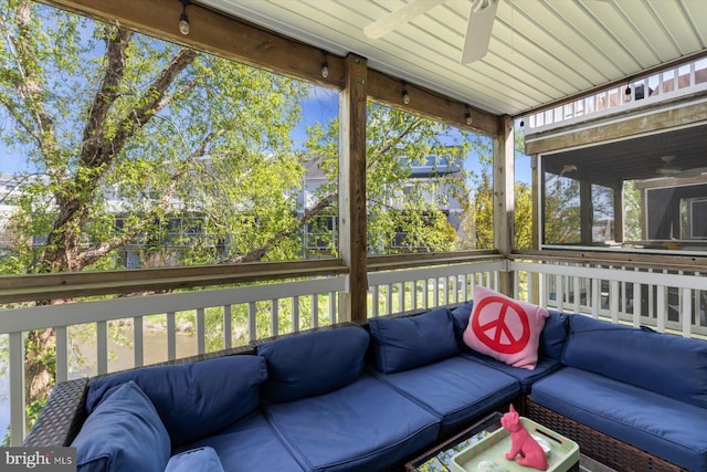 sunroom / solarium with a ceiling fan, a wealth of natural light, and outdoor lounge area